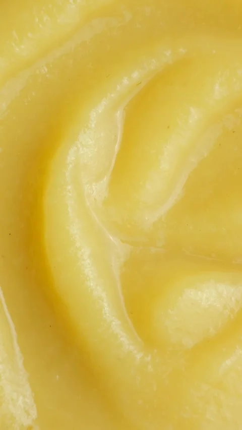 Abstract macro yellow fruit apple sauce background with swirl pattern. Stock Footage 333133375