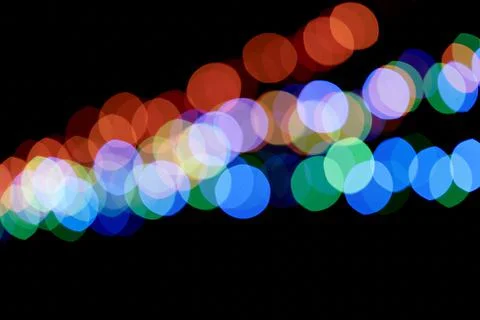 Abstract magic background with bokeh effect. Three multicolored garlands Fotos de archivo