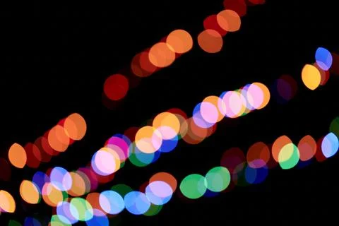 Abstract magic background with bokeh effect. Three multicolored garlands Stock Photos