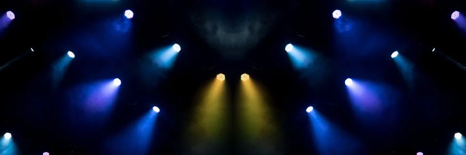 Abstract magic image with rays of colored light from the spotlights in the da Stock Photos