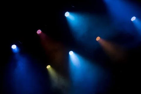 Abstract magic image with rays of colored light from the spotlights in the da Stock Photos