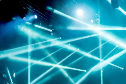 Abstract magic image with rays of colored light from the spotlights in the da Stock Photos