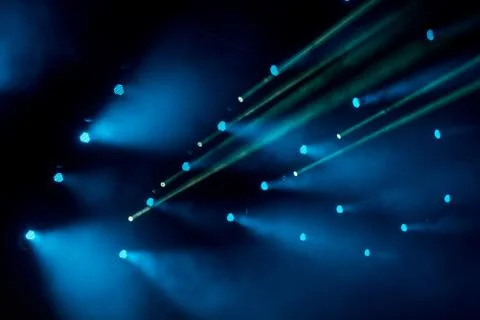 Abstract magic image with rays of colored light from the spotlights in the da Stock Photos