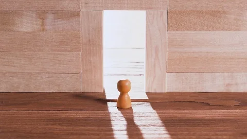 Abstract man in the doorway. Wall of wooden puzzles. Success concept. Stock Footage 100605053