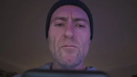 Abstract. Man using smart phone. Light reflected on his face. Hull.UK 7.2.2026 Stock Footage 327654967