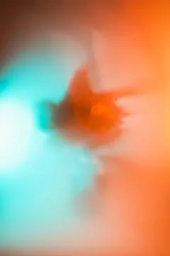Abstract maple leaf blur in vibrant orange and aqua gradient, soft-focus ethe Stock Photos