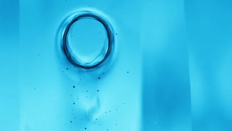 Abstract microscopic liquid cells and blue bubbles flowing in fluid motion Stock Footage 346643577