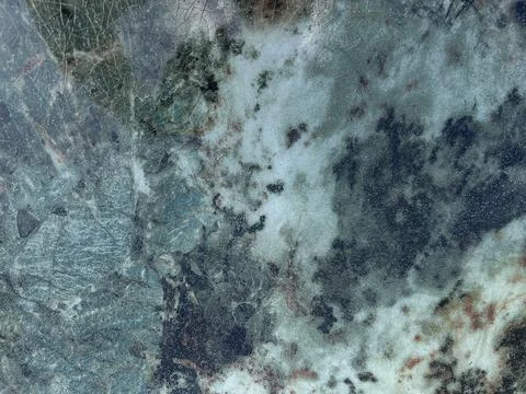 Abstract mineral stone surface with cloudy white veins, dark blue gray patches Stock Photos