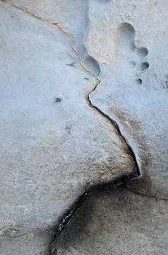 Abstract minimalistic texture of a single line crack on a large rock surface Stock Photos
