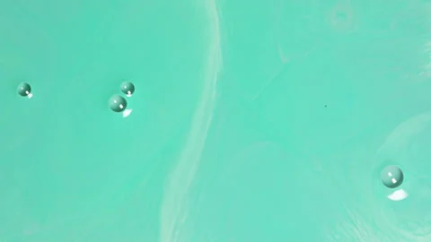 Abstract mint green fluid motion with soft liquid swirls and bubbles 스톡 동영상 331688459