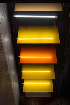 Abstract modern interior architecture with glowing yellow and orange light Stock Photos