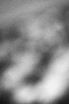 Abstract monochrome grainy texture background with soft light gradients Stock Photos