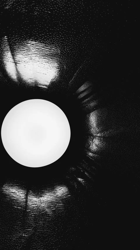 Abstract monochrome light orb behind textured glass creating moody minimalist Stock Footage 327130924