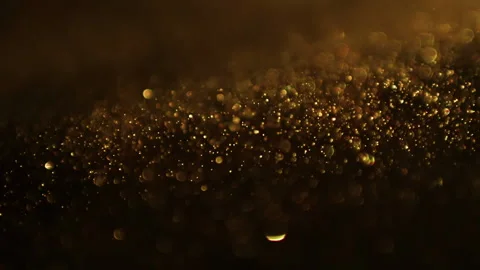 Abstract motion background shining gold particles. Glittering Particles With Video stock 154803089