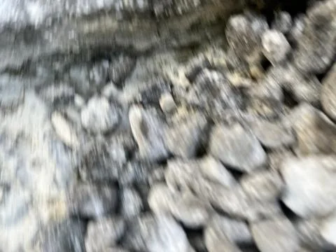 Abstract motion blur background featuring grey natural stones and river rocks Stock Photos