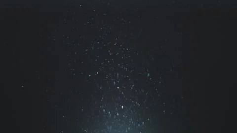 Abstract motion of dust particles flowing in light beam on dark background,.. Stock Footage 337539209