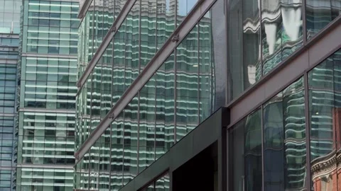Abstract moving city centre view of glass-fronted office buildings Vidéo 241532534