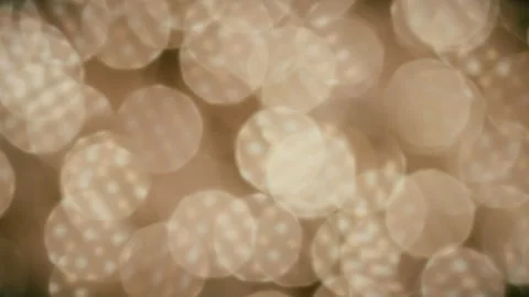 Abstract moving reflective surface creates large bokeh balls. 4K locked tripod Stock Footage 145357166