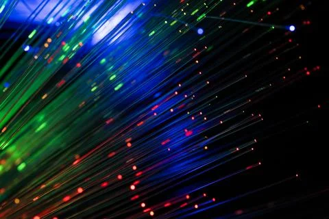 Abstract Multicolor Fiber Optic Light Trails on Dark Background Foto stock