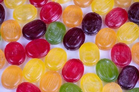 Abstract multicolored candies arranged in pattern, repetitive geometry, glossy h Stock Photos