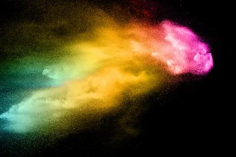Abstract multicolored dust explosion on black background. Stock Photos