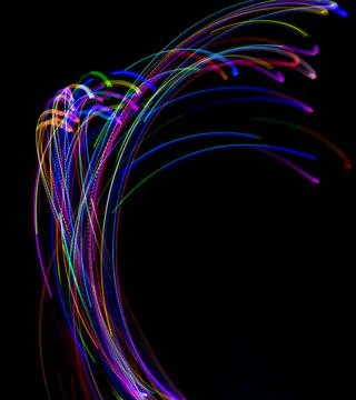 Abstract multicolored lines drawn by light on a black background Stock Photos