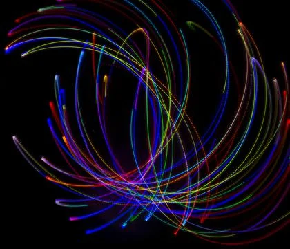 Abstract multicolored lines drawn by light on a black background Stock Photos