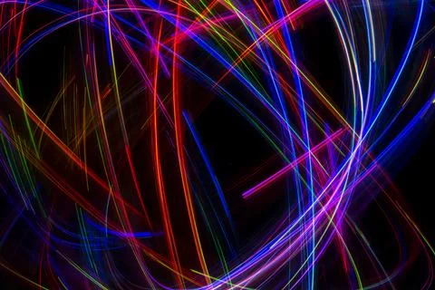 Abstract multicolored lines drawn by light on a black background Stock Photos