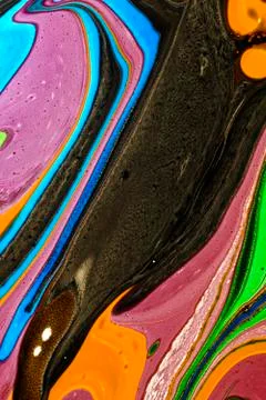 Abstract multicolored liquid solution surface macro close up from above Stock Photos