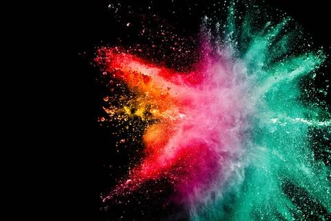 Abstract multicolored powder explosion on black background. Color dust par... Stock Photos