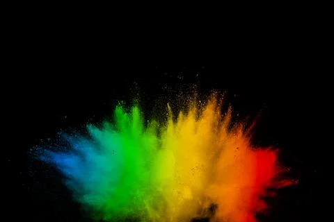 Abstract multicolored powder explosion on black background. Color dust part.. Stock Photos