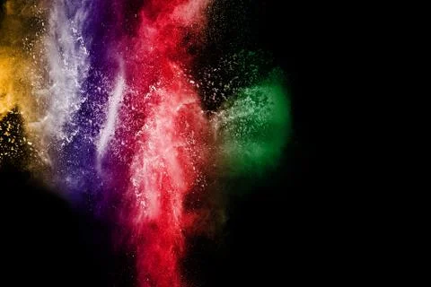 Abstract multicolored powder splatted on black background Stock Photos