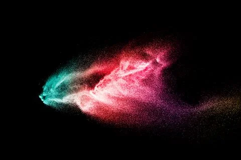 Abstract multicolored sand explosion isolated on black background. Illustrazione stock