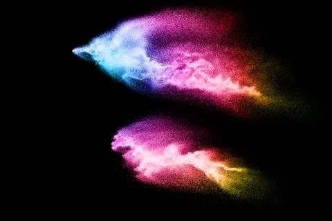 Abstract multicolored sand explosion isolated on black background. Stock Photos