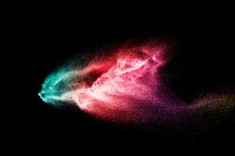 Abstract multicolored sand explosion isolated on black background. Stock Photos