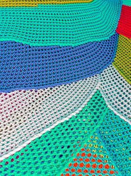 Abstract multicolored saturated bright art background from knitted threads Stock Photos