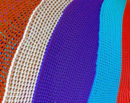 Abstract multicolored saturated bright art background from knitted threads Stock Photos