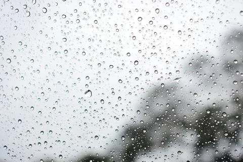 Abstract natural texture of raindrop moisture beads on transparent glass wind Stock Photos