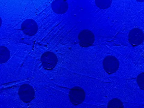 Abstract navy polka dot texture with scattered circles on vibrant blue surf.. Stock Photos