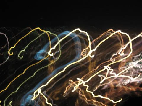 Abstract neon background, movement, multicolored highlights on a black Stock Photos