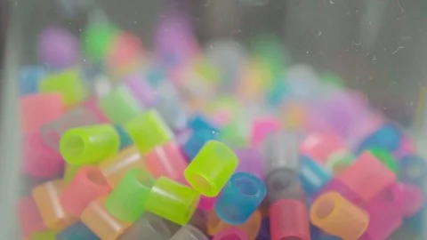 Abstract neon plastic beads are poured Stock Footage 95434059