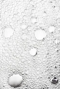 Abstract neutral background from numerous bubbles in water. Stock Photos