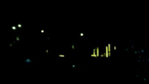 Abstract night scene with blurred city lights creating a mysterious and atm.. Vidéo 340219891