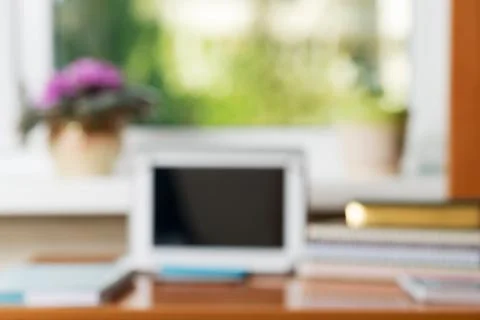 Abstract office desk table with computer, supplies, flower blur background Stock Photos