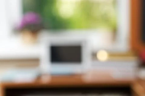 Abstract office desk table with computer, supplies, flower blur background Stock Photos
