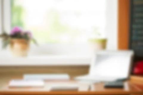 Abstract office desk table with computer, supplies, flower blur background... Stock Photos