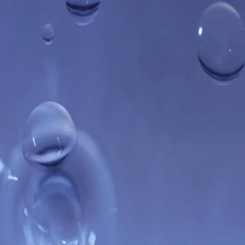 Abstract oil drops falling in blue water Stock Footage 69491344