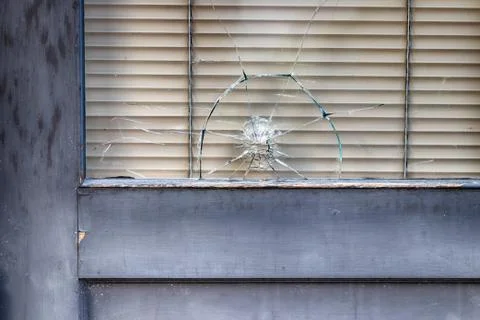 Abstract old building storefront window with bullet hole Stock Photos