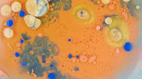 Abstract orange and blue ink bubbles under water Stock Footage 208843374
