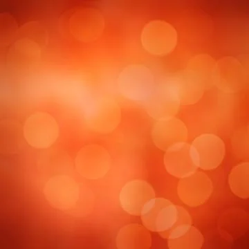 Abstract orange bokeh pattern is featuring glowing circles over warm gradient Foto stock